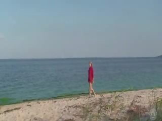 Shy nude girl on the beach